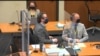 In this image from video, defense attorney Eric Nelson, left, and defendant, former police officer Derek Chauvin, right, listen during jury selection in Chauvin's trial, at the Hennepin County Courthouse in Minneapolis, Minnesota, March 9, 2021.