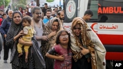FILE - Injured Palestinians arrive at al-Shifa Hospital following Israeli airstrikes on Gaza City, central Gaza Strip, October16, 2023