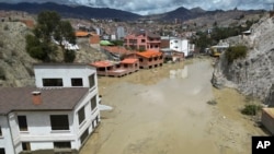 Homes are flooded by the overflowing Pasajahuira River in La Paz, Bolivia, Nov. 24, 2024.