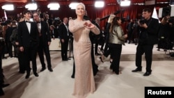 Jamie Lee Curtis poses on the champagne-colored red carpet during the Oscars arrivals at the 95th Academy Awards in Hollywood, Los Angeles, California, March 12, 2023.