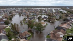  In this Aug. 30, 2021, file photo flooded streets and homes are shown in the Spring Meadow subdivision in LaPlace, La.