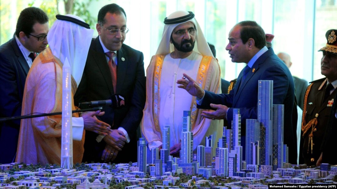 Egyptian President Abdel-Fattah el-Sissi, right, and Prime Minister of the United Arab Emirates (UAE) and Sheikh Mohammed bin Rashid al-Maktoum, center, look at a model of the new Egyptian capital Cairo displayed at the Egypt Economic Conference, March 14, 2015.