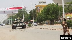 FILE - A Chad army tank is seen on a street as fighters from the rebel Front for Change and Concord in Chad (FACT) appeared to be moving toward the capital, according to the United States, in N'djamena, Chad, April 19, 2021. 