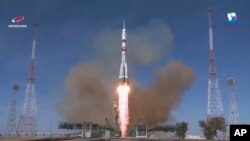 In this image made from video footage released by Roscosmos Space Agency, the Soyuz-2.1a rocket booster with Soyuz MS-17 space ship carrying a new crew to the ISS, blasts off at the Russian leased Baikonur cosmodrome, Kazakhstan, Oct. 14, 2020.