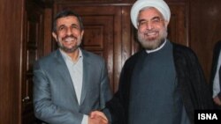 People walk by trees covered with ice from the mist of the falls in Niagara Falls, Ontario, Canada.