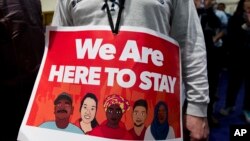 Immigrant rights advocates demonstrate against President-elect Donald Trump's immigration policies, during a rally at Metropolitan AME Church in Washington, Jan. 14, 2017. 