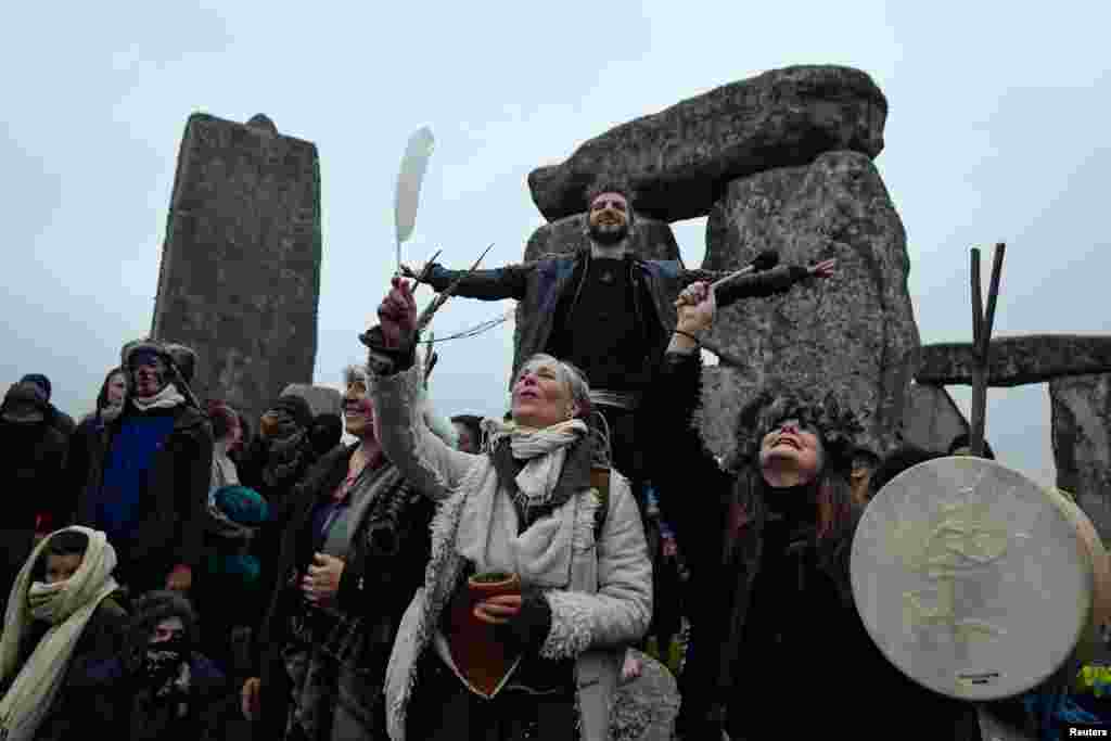 Revelers gather to celebrate the Summer Solstice at Stonehenge ancient stone circle, despite official events being canceled amid the spread of the COVID-19, near Amesbury, Britain.