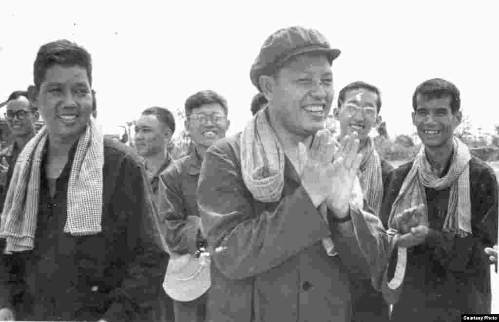 Ieng Sary claps his hands while inspecting the railroad in Takeo province with Deputy Prime Minister in charge of Economics Affairs Vorn Vet and Chinese experts, 1977. (Documentation Center of Cambodia Archive)