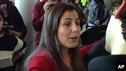 Vahideh Rasekhi, an Iranian doctoral student at Stony Brook University, greets friends and family as she is released from detention at John F. Kennedy International Airport in New York, Jan. 29, 2017.