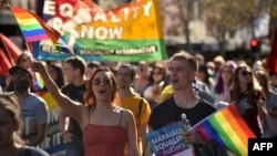 Supporters of same-sex marriage carry banners and shout slogans as they march in Sydney, Australia, Aug. 6, 2017.