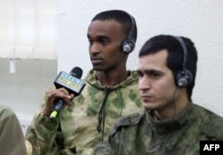 FILE — A POW from Somalia speaks during a press conference organized by Ukrainian officials in Kyiv, on March 15, 2024.