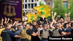 Lebanese army try to block supporters of the Lebanese Shi'ite groups Hezbollah and Amal as they gesture and chant slogans against anti-government demonstrators, in Beirut, June 6, 2020.