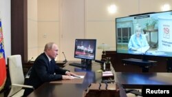 Russian President Vladimir Putin attends a meeting with head of the Central Election Commission Ella Pamfilova, via a video conference call at the Novo-Ogaryovo state residence outside Moscow, Sept. 20, 2021. (Sputnik/Alexei Druzhinin/Kremlin via Reuters)