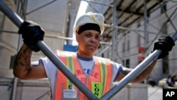 FILE: In this Aug. 14, 2014 photo, Sophia Johnson stands for a photo outside a construction site where she works as a shop steward, in New York. 