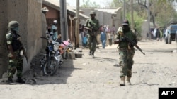 FILE - Nigerian soldiers are seen patrolling Baga, a town in the northeastern state of Borno, April 30, 2013.