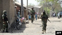 Nigerian soldiers are seen patrolling a town in the north-eastern state of Borno in this April 30, 2013, file photo.