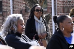 Carolyn Highsmith, a member of Theta Epsilon Omega Chapter of Alpha Kappa Alpha Sorority in New Haven, listens to speakers at a Souls to the Polls voting rally at Grace Baptist Church, Oct. 26, 2024, in Waterbury, Conn.