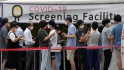 People queue in line to wait for the coronavirus testing at a Public Health Center in Seoul, South Korea, July 9, 2021.