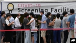 People queue in line to wait for the coronavirus testing at a Public Health Center in Seoul, South Korea, July 9, 2021.