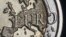 The map of Europe is featured on the face of a two Euro coin seen in this photo illustration.