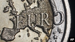 The map of Europe is featured on the face of a two Euro coin seen in this photo illustration. 