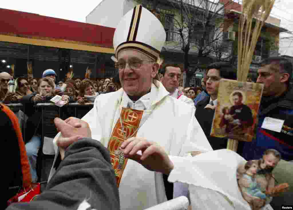 Archbishop of Buenos Aires Cardinal Jorge Bergoglio greets worshippers during the annual gathering and pilgrimage to the church dedicated to San Cayetano (Saint Cajetan), the patron saint of labor and bread, in the Buenos Aires neighbourhood of Liniers, A