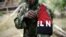 FILE - A rebel of Colombia's Marxist National Liberation Army shows his armband while posing for a photograph, in the northwestern jungles, Colombia Aug. 31, 2017. 
