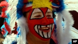 FILE - Mike Margevicus, a fan of the Cleveland Indians Baseball team, waiting to enter Jacobs Field for the team's home opener Friday, April 10, 1998, in Cleveland, Ohio. Nearby demonstrators protested the Indians mascot, Chief Wahoo, as racist. 