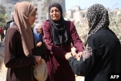 FILE—Palestinian women react as they inspect the damage surrounding Gaza's Al-Shifa hospital after the Israeli military withdrew from the complex housing the hospital on April 1, 2024.