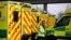 A paramedic walks amid ambulances outside London's Excel Centre, while it is being prepared to become a hospital for the treatment of coronavirus patients, in London, Britain, March 28, 2020.