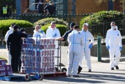 Response personnel prepare to distribute goods to residents inside a public housing tower, locked down in response to an outbreak of the coronavirus disease (COVID-19), in Melbourne, Australia, July 9, 2020.