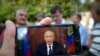 RUSSIA -- A man watches on his smartphone Russian President Vladimir Putin's televised address on pension reform, in Moscow, August 29, 2018