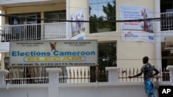 FILE - A man paints the electoral commission office in Yaounde, Cameroon, Oct. 10, 2018. 