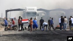 Anti-government protesters re-block the port of Umm Qasr Iraq, Nov. 7, 2019.