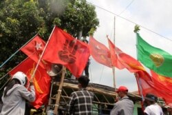 Demonstrators display flags during a protest in Launglone, Dawei district, Myanmar on March 26, 2021. (Dawei Watch/Reuters)