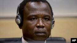 Dominic Ongwen, a Ugandan commander in warlord Joseph Kony's feared militia, waits for the judge to arrive as he made his first appearance at the International Criminal Court in The Hague, Netherlands, Jan. 26, 2015.