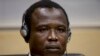 Dominic Ongwen, a Ugandan commander in warlord Joseph Kony's feared militia, waits for the judge to arrive as he made his first appearance at the International Criminal Court in The Hague, Netherlands, Jan. 26, 2015.