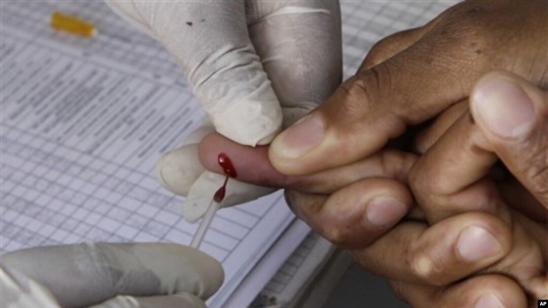 A patient undergoes a pin prick blood test inside a mobile healthcare clinic parked in downtown Johannesburg, 29 Nov 2010