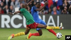 FILE - France's Blaise Matuidi, right, is tackled by Cameroon's Allan Nyom during a friendly soccer match between France and Cameroon at the La Beaujoire Stadium in Nantes, France, May 30, 2016.