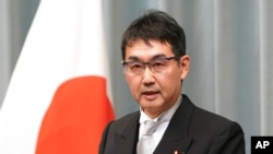 FILE - Japan's Justice Minister Katsuyuki Kawai speaks during a press conference at the prime minister's official residence in Tokyo.