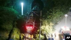 Rescue crews work at the derailed train near Taroko Gorge in Hualien, Taiwan, April 2, 2021. The train partially derailed in eastern Taiwan on Friday after colliding with an unmanned vehicle that had rolled down a hill. 