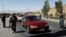 Afghan security forces keep watch at a checkpoint on the Ghazni highway, in Maidan Shar, the capital of Wardak province, Afghanistan, Aug. 12, 2018.