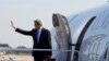 U.S. Secretary of State John Kerry waves as he boards his plane at Andrews Air Force Base in Maryland on his way to Doha, June 21, 2013. 