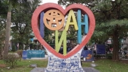 A Hanoi sign, seen from behind, graces a park in the Vietnamese capital. (VOA News)