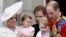 Britain's Prince William holding Prince George, right and Kate, Duchess of Cambridge holding Princess Charlotte, left, on the balcony at Buckingham Palace. 