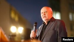 Former Soviet President Mikhail Gorbachev visits the former Berlin Wall border crossing point Checkpoint Charlie, in Berlin, November 7, 2014. 