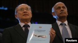 Kepala Tim Investigasi Pesawat MH370, Kok Soo Chon menunjukkan buku laporan investigasi keselamatan MH370 ke media setelah konferensi pers di Putrajaya, Malaysia, 30 Juli 2018.