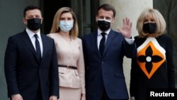 French President Emmanuel Macron and his wife Brigitte Macron welcome Ukraine's President Volodymyr Zelenskiy and his wife Olena for a working lunch at the Elysee Palace in Paris, France, April 16, 2021.