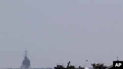 An Israeli military vessel (L) arrives at the navy port of Ashdod in southern Israel, 05 Jun 2010