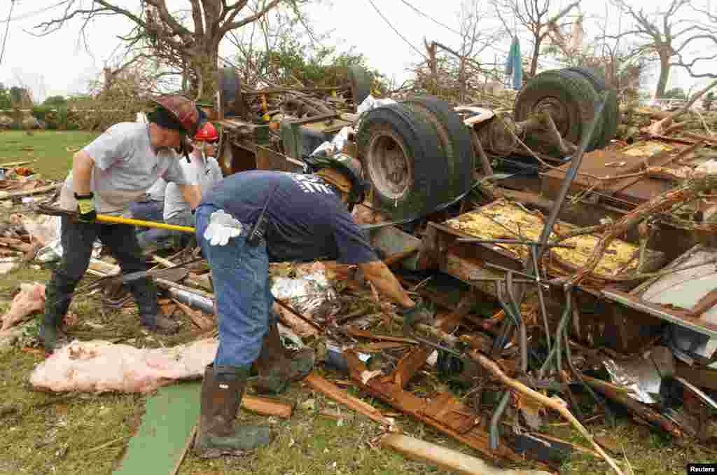 Rescue workers comb through debris after a tornado swept through Granbury, Texas, May 16, 2013.